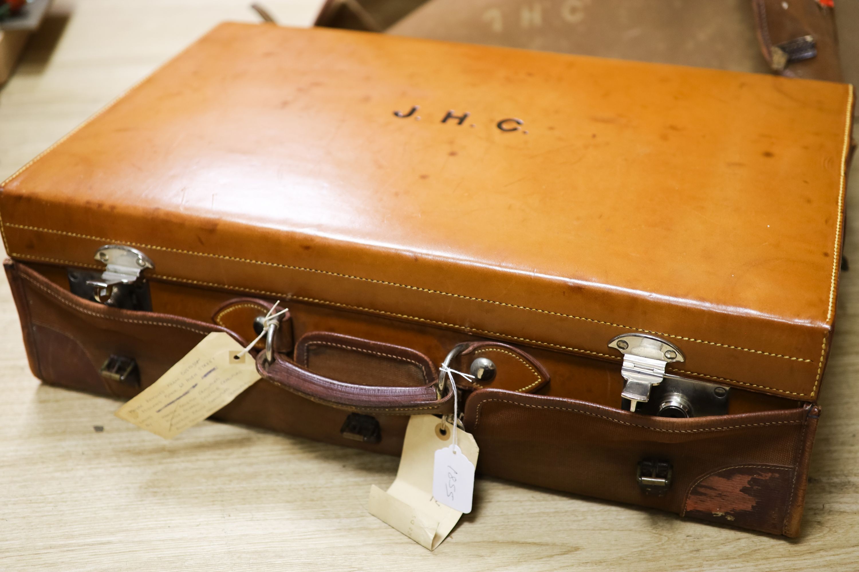 A 1930's Harrods pigskin travelling toilet case with seven engine turned silver fittings, including brushes, cigarette box and two scent bottles, F & Co Ltd, London, 1933, case 66.5cm.